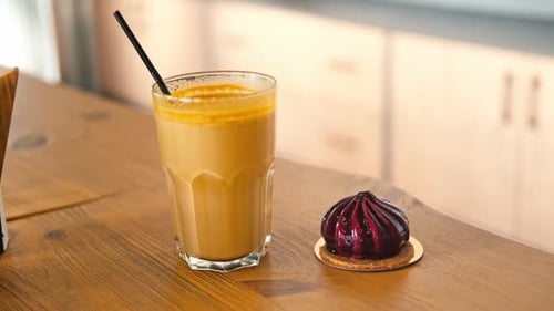 Cake with Latte on the Bar on a Wooden Cafe Table Coffee Shop Restaurant Interior Background Yellow