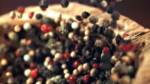 Colorful Peppercorns Falling Into Rustic Wooden Bowl
