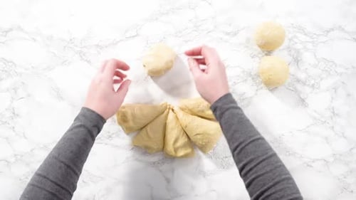 Hands Kneading Dough on Marble Countertop, Overhead