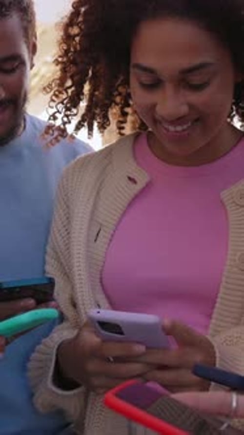 Young Adults Looking at Smartphones Together