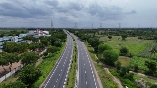 Scenic highway in Chennai bordered by green spaces, blending nature with infrastructure