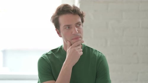 Young Adult Thinking Indoors During Daytime