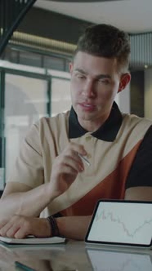 Broker Explaining Details of Financial Project on Tablet with Trading Screen