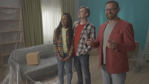 A Young Couple with a Real Estate Agent Visiting an Apartment to Buy or Rent Apartment Purchase