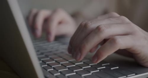 Close Up of Hands Typing on Laptop Keyboard