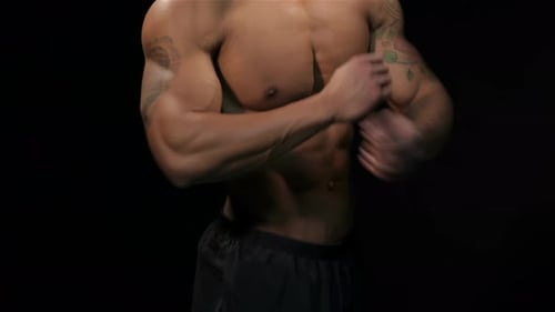 Muscular Man Crossing Arms With Tattoos