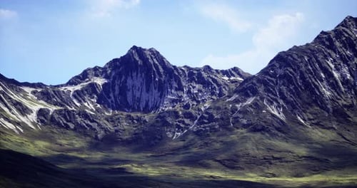 Breathtaking View of Rugged Mountains Under a Clear Blue Sky