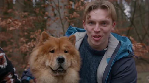 Man Hugging and Petting Chow Chow Dog