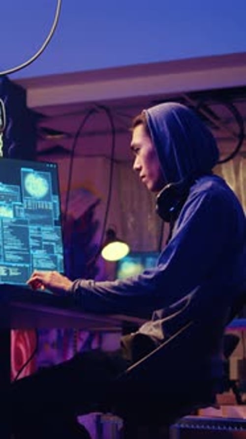Young Adult Coding with Multiple Computer Screens