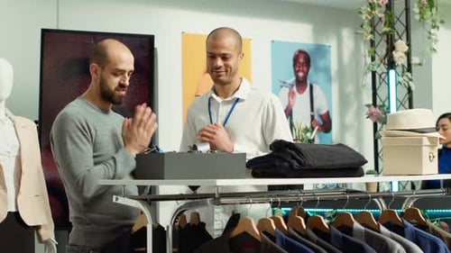 Man Browsing Accessories in a Clothing Store