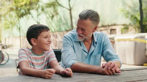 Grandfather and Grandson Having Fun at a Park
