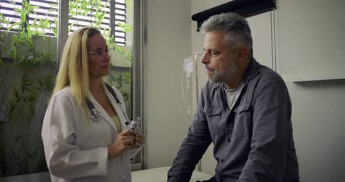 Doctor Explains Medication to Patient in Medical Office