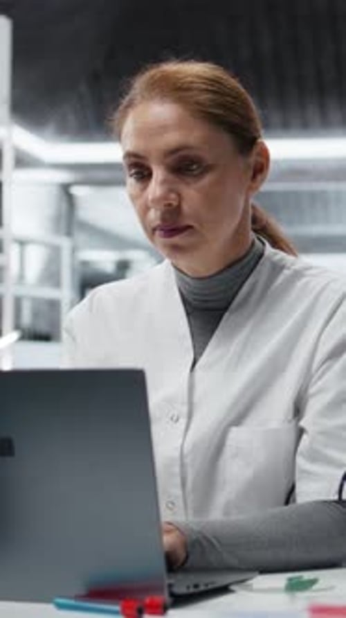 Woman Scientist Working at Laptop in Laboratory