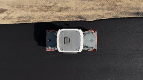 Road roller pressing fresh put Asphalt on a new road