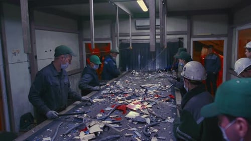 Man Sorts Garbage Electronics or Plastic Waste Recycling Plant or Garbage Factory Conveyor Belt