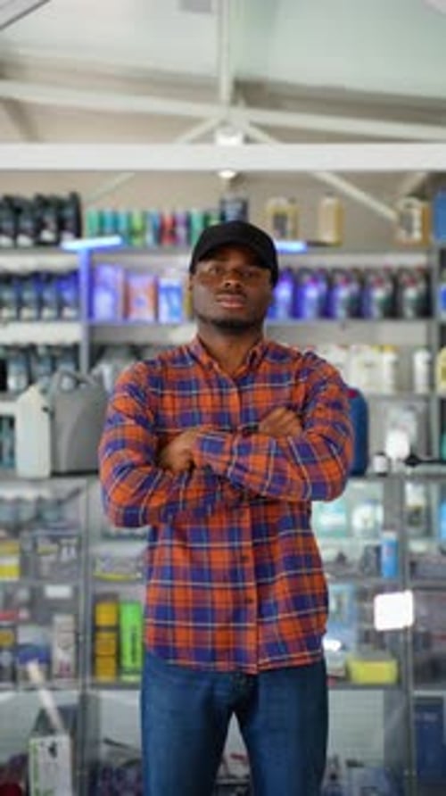 Portrait of African American Salesman in an Auto Parts Store The Concept of Car Repair Vertical
