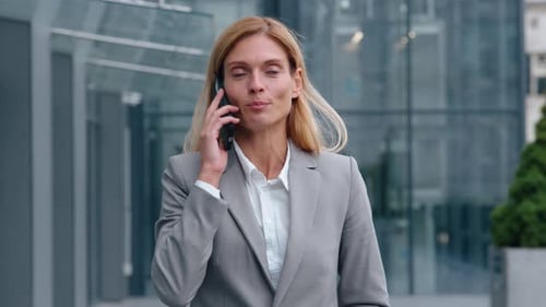 Smiling Caucasian Adult Businesswoman Walking in City Talking Phone Business Call Discuss Middleaged