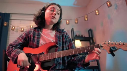 Close Up Footage of Portrait Cheerful Teenager Woman Playing Guitar While Sitting