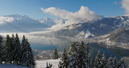 Winter Landscape Of Mountains, Lake, And Pine Trees