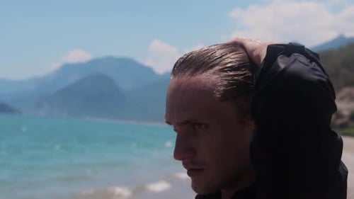 Handsome Man Posing on a Beach on Sunny Day