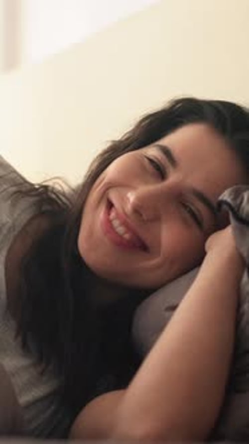 Woman Waking Up Smiling in Bed Close Up