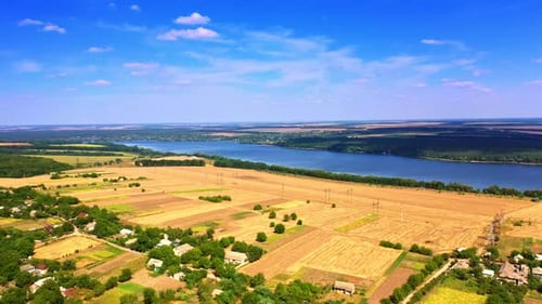 Amazing scenery of picturesque landscapes on clear sunny day. Yellow wheat fields near the river.