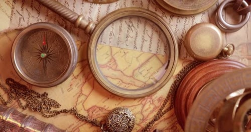 Vintage style travel and adventure. Vintage old compass and other vintage items on the table.