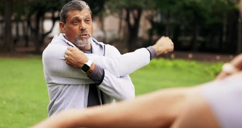 Man Stretching his Arms in a Park