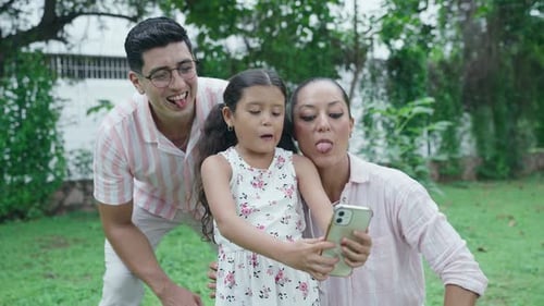 Daughter Taking Selfie with Mom and Dad in the Park