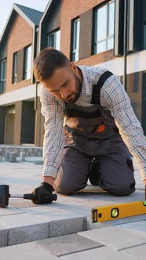 Professional Paver Installing Concrete Paving Slabs