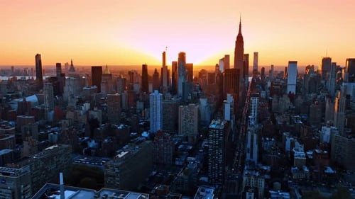 Bright setting sun behind the skyline of gorgeous New York.