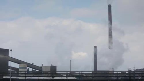 Rooftop german factory, chimneys polluting the air with smoke, global warming