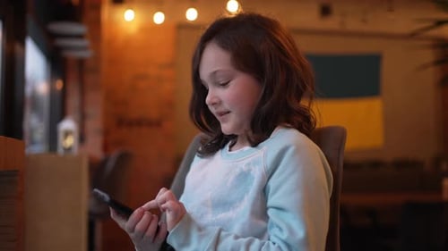 Girl Using Cellphone Indoors