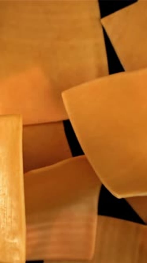 Sliced Cheddar Cheese Flies on a Black Background Filmed on a Highspeed Camera at 1000 Fps