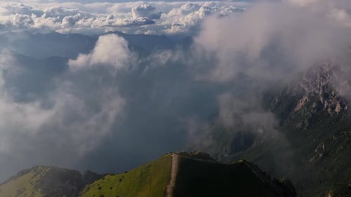 Aerial Flight over Monte Baldo Ridge in the Clouds, Lake Garda, Italian Alps