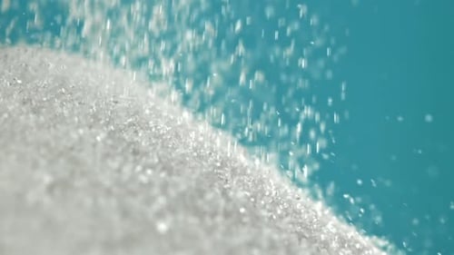 Sugar Falling in a Pile on a Blue Background Filmed on a Highspeed Camera at 1000 Fps