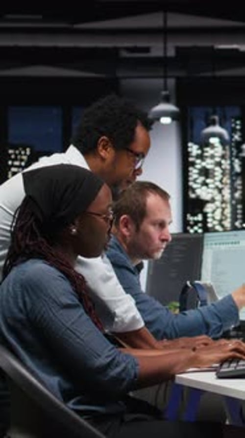 Vertical Video Team of Programmers in Office Working Together to Block Hacker Intrusion