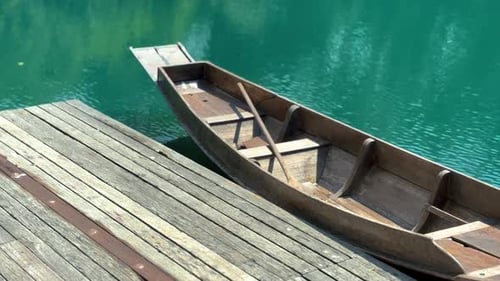 Boat parks in turquoise lake calmly