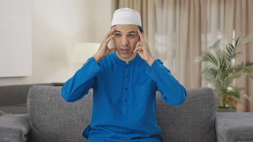 Man Rubbing Head in Pain