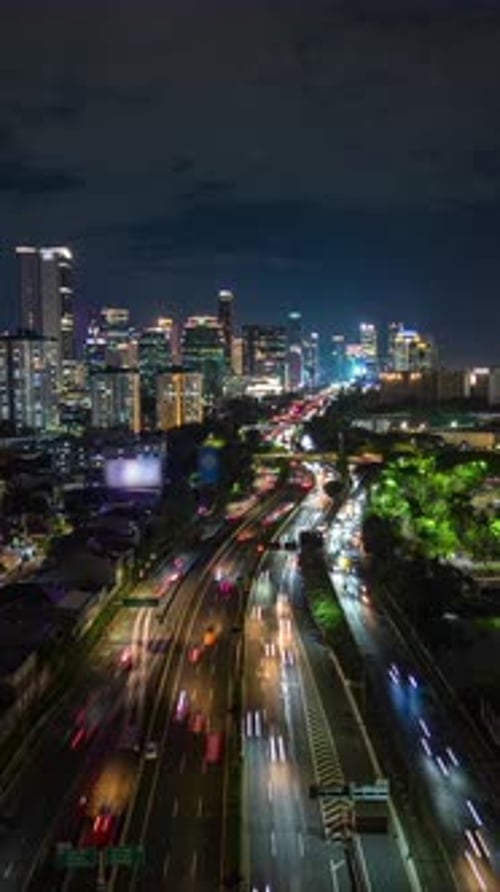 Aerial Timelapse of Jakarta City Skyline with Highway Traffic at Night Indonesia