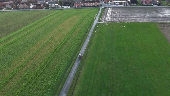 Tractor on path on agricultural farm fields in winter. Rainy day in ...
