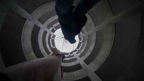 Looking Up in Spiral Parking Garage with Two People