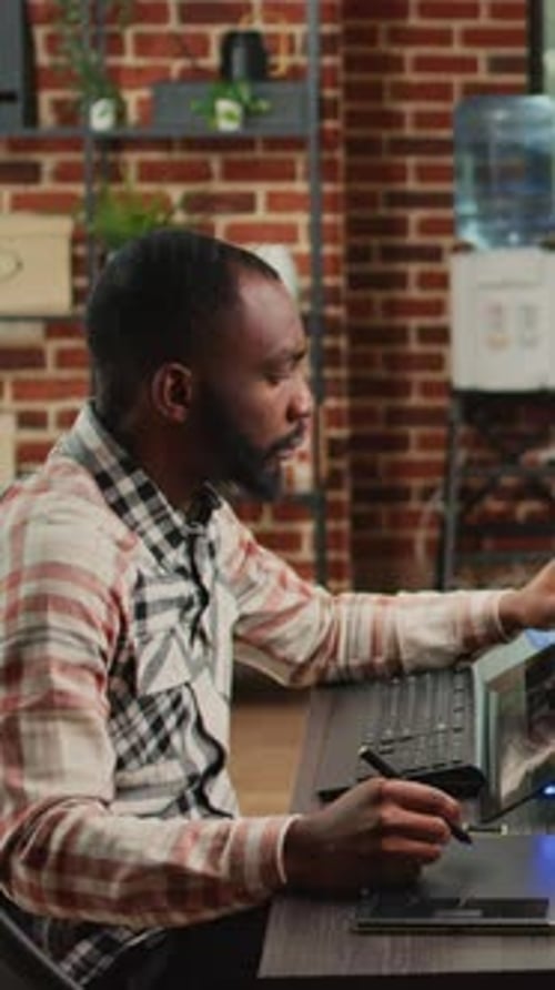 Man Uses Stylus on Screen in Sleek Office