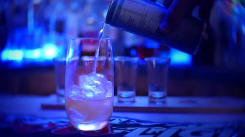 Drink being poured in bar at night