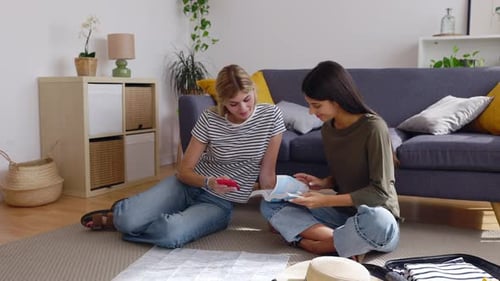 Women Planning Travel Adventure with Map and Smartphone