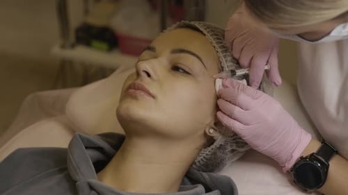 Woman Receiving Cosmetic Injection in Medical Clinic