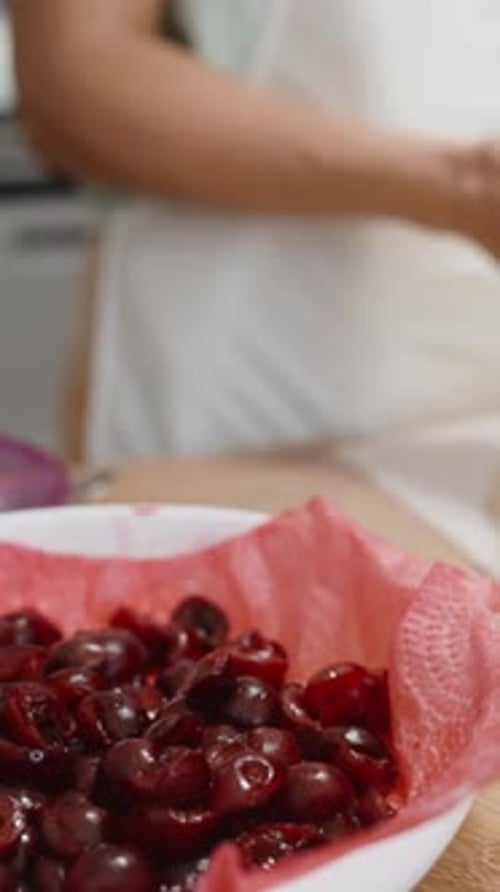 Woman Puts Cherries on Pastry Dough for Baking