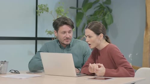 Business People Discussing Online Work on Laptop