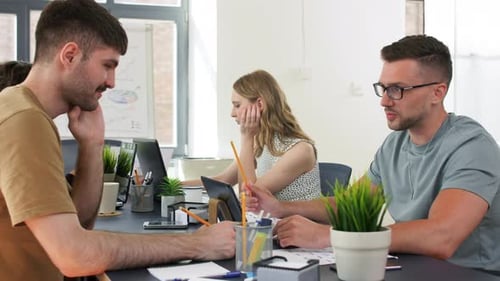 Creative Team Collaborating on Project in Modern Office