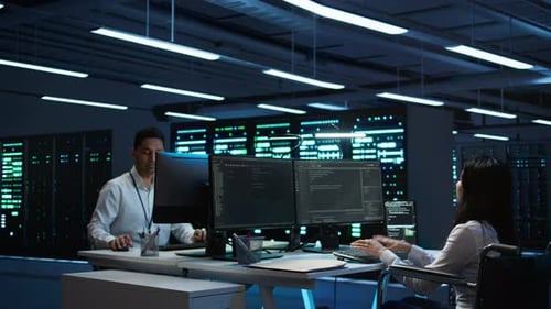 Person with Paraplegia Working in Inclusive Server Hub Workspace Typing on PC